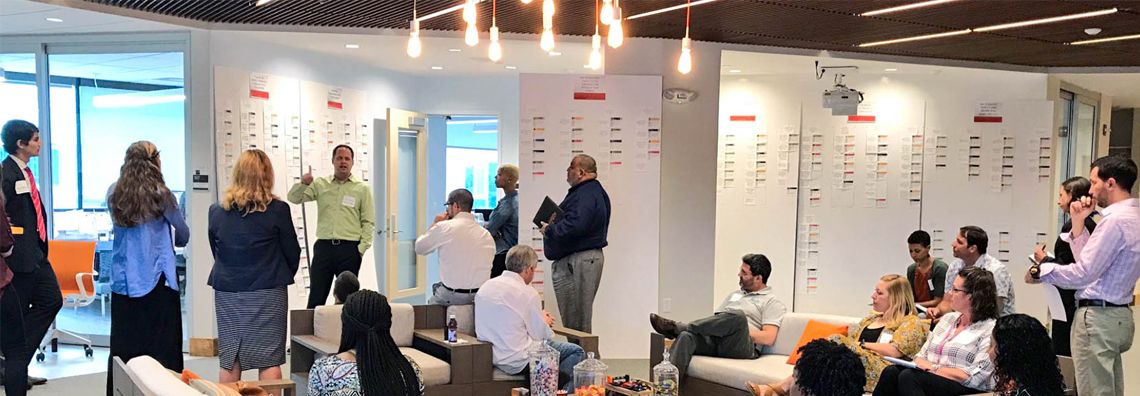 Research wall with persona cards and sticky notes beside mobile UI storyboards